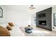 Comfortable living room with a stylish fireplace and bright open-concept design at 17414 N 56Th Way, Scottsdale, AZ 85254