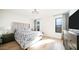 Well-lit main bedroom showcases an upholstered headboard, dark wood furniture, and an elegant chandelier at 17414 N 56Th Way, Scottsdale, AZ 85254