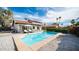 Refreshing pool with clear blue water, surrounded by a patio and lush greenery, under a bright blue sky at 17414 N 56Th Way, Scottsdale, AZ 85254