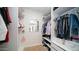 Organized walk-in closet with custom shelving, hanging rods, and a central mirror at 17414 N 56Th Way, Scottsdale, AZ 85254