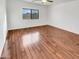 Bedroom with wood floors, a ceiling fan, and a window to bring in natural light at 17649 W Young St, Surprise, AZ 85388