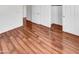 Bright bedroom with wood-look flooring, open closet and white doors at 17649 W Young St, Surprise, AZ 85388