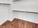 A closet with hardwood floors and ample shelf space for storage and organization at 17649 W Young St, Surprise, AZ 85388