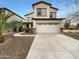 Two story home featuring an attached two car garage, neutral colors, and rock accents at 17649 W Young St, Surprise, AZ 85388