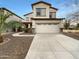 Two story home featuring an attached two car garage, neutral colors, and rock accents at 17649 W Young St, Surprise, AZ 85388