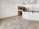 Open-concept kitchen features wood cabinets, granite countertops, stainless appliances, and bar top overlooking dining area at 17649 W Young St, Surprise, AZ 85388