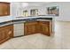This kitchen showcases sleek stainless steel appliances, ample wood cabinets, and tile floors for modern functionality at 17649 W Young St, Surprise, AZ 85388