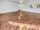 Spacious living room with hardwood floors, ceiling fan, and abundant natural light from several large windows at 17649 W Young St, Surprise, AZ 85388