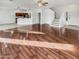 Open living room with wood floors, a ceiling fan, and an open-concept kitchen at 17649 W Young St, Surprise, AZ 85388
