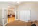 Bedroom with neutral walls featuring an open doorway with views of the dining area and living spaces at 18215 N Shadow Ct, Surprise, AZ 85374