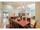 Spacious dining room features a large table, pendant lighting, and access to other living spaces at 18215 N Shadow Ct, Surprise, AZ 85374
