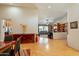 Open dining room displaying hardwood floors, modern chandelier, and views into the spacious living room at 18215 N Shadow Ct, Surprise, AZ 85374