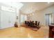 Bright formal dining room featuring hardwood floors, a modern chandelier, and views of the front yard at 18215 N Shadow Ct, Surprise, AZ 85374