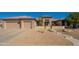 Charming single-story home featuring desert landscaping, tiled roof, and an attached two-car garage at 18215 N Shadow Ct, Surprise, AZ 85374