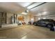 Organized garage showcasing storage solutions, utility sink, and ample parking space at 18215 N Shadow Ct, Surprise, AZ 85374