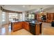 Bright eat-in kitchen area featuring granite counters, a breakfast bar, and access to the living room at 18215 N Shadow Ct, Surprise, AZ 85374