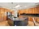Beautiful kitchen with custom wood cabinetry, granite counters, an island, and stainless steel appliances at 18215 N Shadow Ct, Surprise, AZ 85374