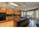 Updated kitchen featuring granite counters, stainless steel appliances, wood cabinets, and a center island at 18215 N Shadow Ct, Surprise, AZ 85374