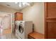 Spacious laundry room featuring modern washer and dryer with cabinetry for ample storage at 18215 N Shadow Ct, Surprise, AZ 85374