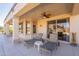 Relaxing covered patio featuring lounge chairs and stylish sliding glass doors to the interior at 18215 N Shadow Ct, Surprise, AZ 85374