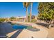 Inviting backyard pool with mature trees, privacy fence, and desert landscaping at 18215 N Shadow Ct, Surprise, AZ 85374