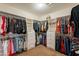 A large walk-in closet provides ample storage with built-in shelving and drawers at 18215 N Shadow Ct, Surprise, AZ 85374