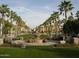 Picturesque community park with lush green lawns, palm trees, benches, and a beautiful water fountain at 20221 W Roma Ave, Litchfield Park, AZ 85340