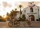 Vibrant community with Main Street Market, local stores, palm trees, and residents on bicycles at 20221 W Roma Ave, Litchfield Park, AZ 85340