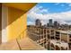 Balcony view of the city skyline with seating and beautiful blue skies at 207 W Clarendon Ave # 5H, Phoenix, AZ 85013