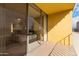 Balcony view through sliding glass doors to a bedroom with a bed and furnishings at 207 W Clarendon Ave # 5H, Phoenix, AZ 85013