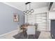 Modern dining room with a round wooden table and stylish lighting fixture at 207 W Clarendon Ave # 5H, Phoenix, AZ 85013