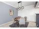 Modern dining room with a round wooden table and stylish lighting fixture at 207 W Clarendon Ave # 5H, Phoenix, AZ 85013