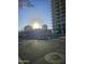 View of the high-rise building from across the street, with the sun beaming brightly at 207 W Clarendon Ave # 5H, Phoenix, AZ 85013