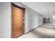 Hallway with carpet flooring, white walls and a door at the end of the hall at 207 W Clarendon Ave # 5H, Phoenix, AZ 85013