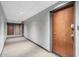 Hallway with carpet flooring, white walls and a door at the end of the hall at 207 W Clarendon Ave # 5H, Phoenix, AZ 85013