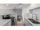 Bright kitchen features white cabinets, modern backsplash, and stainless steel appliances at 207 W Clarendon Ave # 5H, Phoenix, AZ 85013