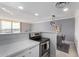 Galley kitchen with stainless steel appliances, stone countertops, and a view to the dining area at 207 W Clarendon Ave # 5H, Phoenix, AZ 85013