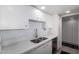 Bright kitchen with white cabinets, stylish backsplash, and stainless steel appliances at 207 W Clarendon Ave # 5H, Phoenix, AZ 85013