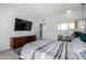 Spacious bedroom with a wooden dresser, TV, and access to the balcony at 207 W Clarendon Ave # 5H, Phoenix, AZ 85013