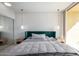 Inviting bedroom with accent wall, plush bedding, and floor-to-ceiling windows at 207 W Clarendon Ave # 5H, Phoenix, AZ 85013