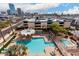 Aerial view of pool and spa area with lounge chairs and umbrellas, plus city skyline views at 207 W Clarendon Ave # 5H, Phoenix, AZ 85013