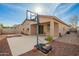 A view of the patio and backyard with a basketball hoop at 21198 W Berkeley Rd, Buckeye, AZ 85396