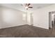 Large bedroom featuring carpet floors, a ceiling fan, and windows providing ample natural light at 21198 W Berkeley Rd, Buckeye, AZ 85396