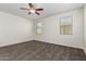 Cozy bedroom featuring carpet floors, a ceiling fan, and windows providing ample natural light at 21198 W Berkeley Rd, Buckeye, AZ 85396