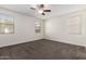 Bright, spacious bedroom with neutral walls, carpeted floors, and natural light from multiple windows at 21198 W Berkeley Rd, Buckeye, AZ 85396