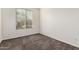 Bright bedroom with a large window that lets in natural light, and neutral carpet at 21198 W Berkeley Rd, Buckeye, AZ 85396