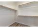 Walk-in closet featuring wooden railings providing ample storage space at 21198 W Berkeley Rd, Buckeye, AZ 85396