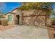 Well-maintained home featuring desert landscaping, a cozy entryway, and an attached two-car garage with an automatic door at 21198 W Berkeley Rd, Buckeye, AZ 85396