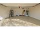 View of the spacious, well-lit garage with epoxy flooring and ample storage space at 21198 W Berkeley Rd, Buckeye, AZ 85396