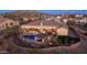 Beautifully landscaped backyard with a pool, spa, outdoor kitchen, and fire pit seating area at 2330 N Channing --, Mesa, AZ 85207